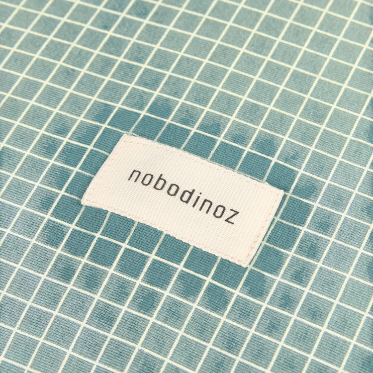 ##STORIES. Changing cover Limited edition - organic cotton jersey Teal Cream Grid 50x70
